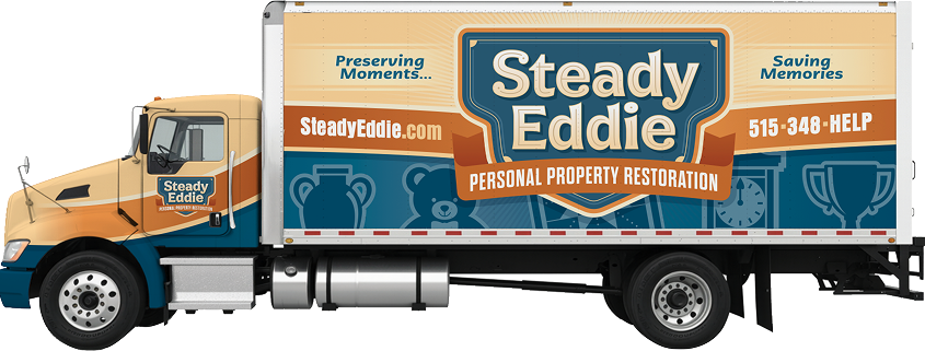 A Steady Eddie personal property restoration truck featuring the company logo, contact information, and the slogans "Preserving Moments..." and "Saving Memories" on the side.